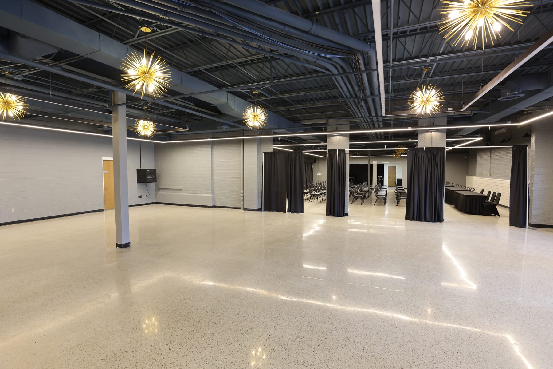 The Event Center's main room beneath its starburst chandeliers